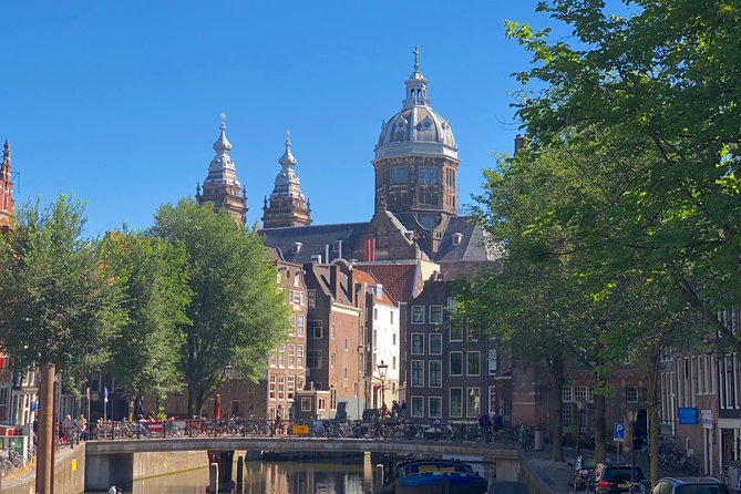 Absolutely Amsterdam - the Essential Introductory Walking Tour - Damrak and the Red Light District: Church, Profit, and Policy