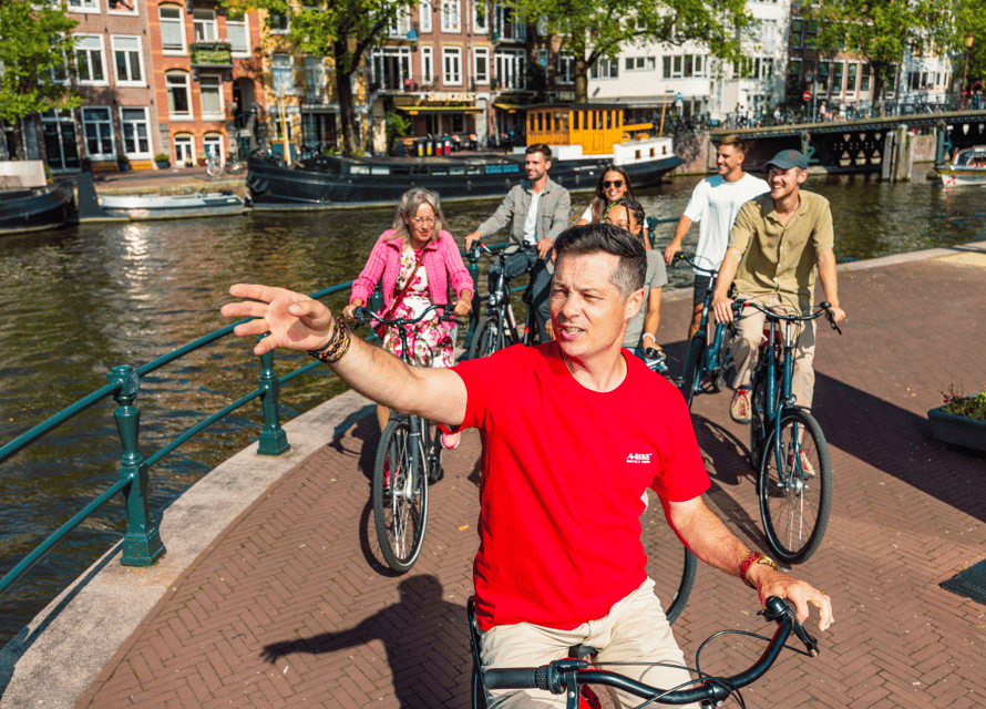 Amsterdam: 2.5-Hour Bike Tour - Riding through neighborhoods, then pausing near Marineterrein and Central