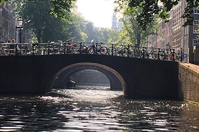 Amsterdam 90-min Private Canal Cruise with Live Guide and Drinks - Amstel and Monet’s canal light: old origins meeting modern lines