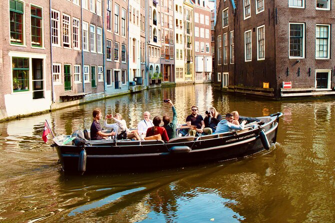 Amsterdam Canal Tour by Open Boat – 90 min Small Group Experience - Munt Tower and the way the city changes canal to canal