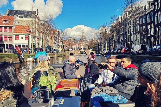 Amsterdam Canal Tour by Open Boat – 90 min Small Group Experience - De Wallen from the water: Oudezijds Voorburgwal, old churches, and contrast