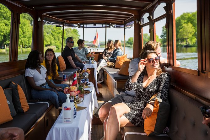 Amsterdam Classic Saloon Boat Cruise with Drinks and Cheese - Getting your best views: practical tips for boarding and comfort