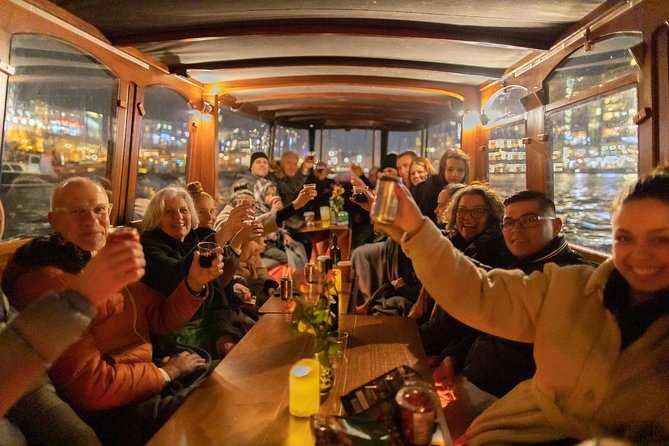 Amsterdam Evening Canal Cruise with Live Guide and Onboard Bar - Magere Brug and the Munttoren, small structures with big stories