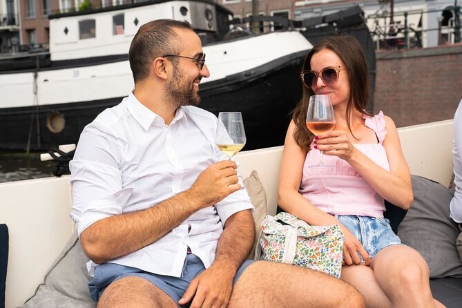 Amsterdam: Evening Candle Light Cruise With Wine & Cheese - Damrak, the Dancing Houses, and the Jordaan seven-bridge viewpoint