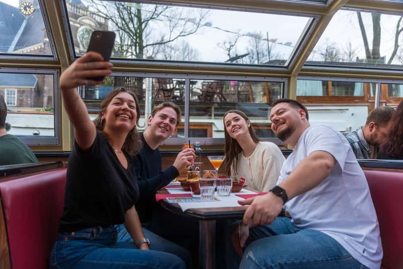 Amsterdam: Evening Cocktail Cruise along the canals - Getting on the boat at Damrak Pier 4 and finding your best spot