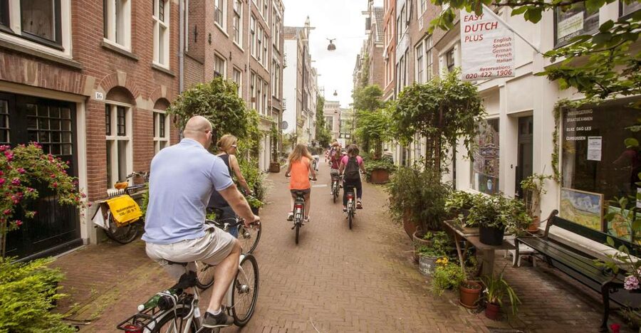 Amsterdam: Hidden Gems & Highlights Guided Bike Tour - Jordaan Backstreets: Courtyards, Churches, and Canal Crossings