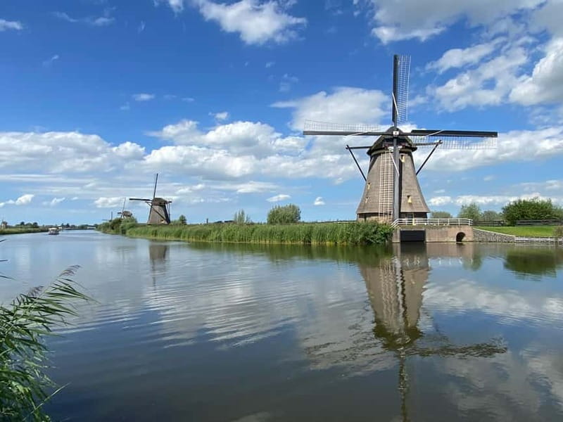 Amsterdam: Kinderdijk, Euromast, Delft and Den Haag Day Tour - Delft on foot: medieval towers, canals, and gables without the Amsterdam crowds