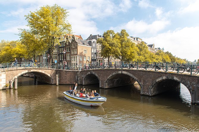 Amsterdam Open Boat Tour with Local Guide - Boarding basics: 1 hour, up to 30 people, and smart-casual comfort