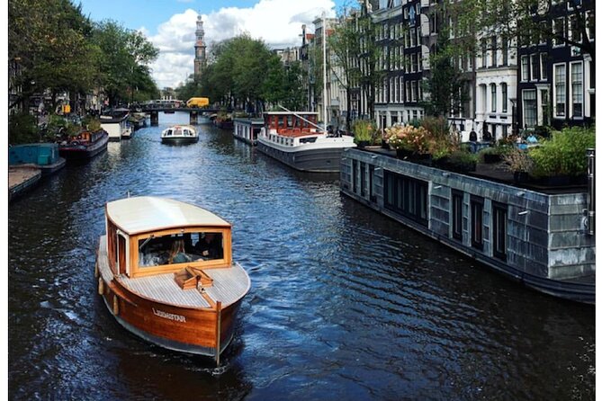 Amsterdam small-group canal cruise in 1920s saloon boat - The Anne Frank House stop, from the waterline perspective