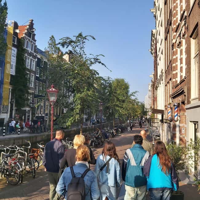 Amsterdam: Spanish Tour Unmasking the Redlight District - Practical tips before you go: comfort, cameras, and adult themes