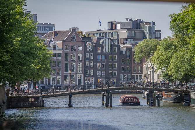 Anne Frank Private Bike Tour in Amsterdam - Stop 1: The Amstel and the WWII story runs alongside the water