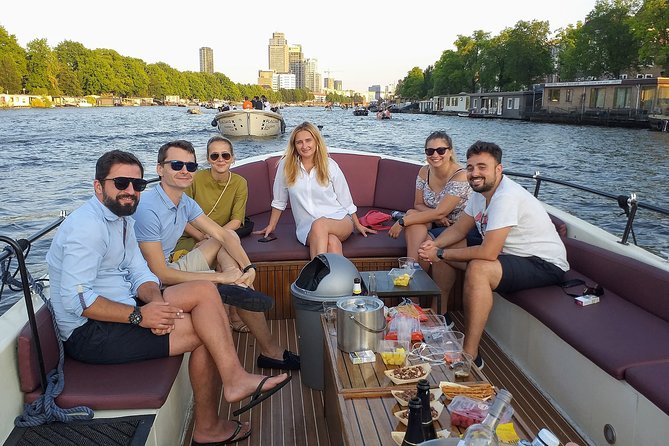 Guided Amsterdam Canal Cruise – Snacks & Drinks on board(1 Hour) - The small-boat vibe, guides you remember, and open-air views