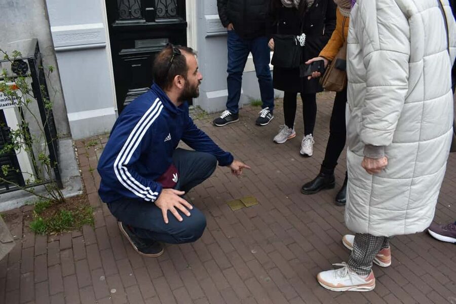 Liberal Amsterdam: Small-Group Walking Tour & Anne Frank VR - The extra touches: coffee, chocolate, Polaroids, and a postcard with a stamp